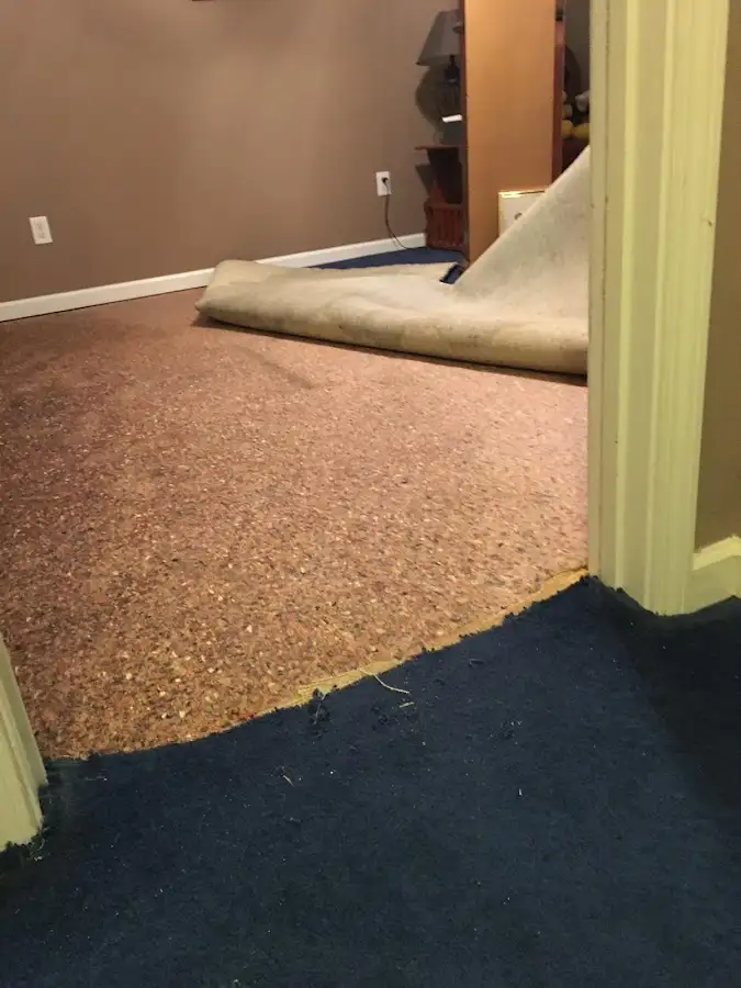 Carpet pad removal revealing water damage during Drying & Dehumidification in Maili