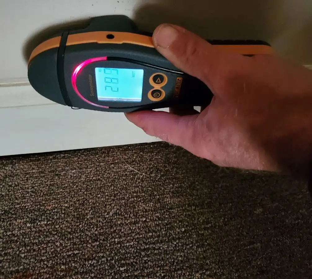Moisture detection at baseboard during Storm Damage Restoration in Maili